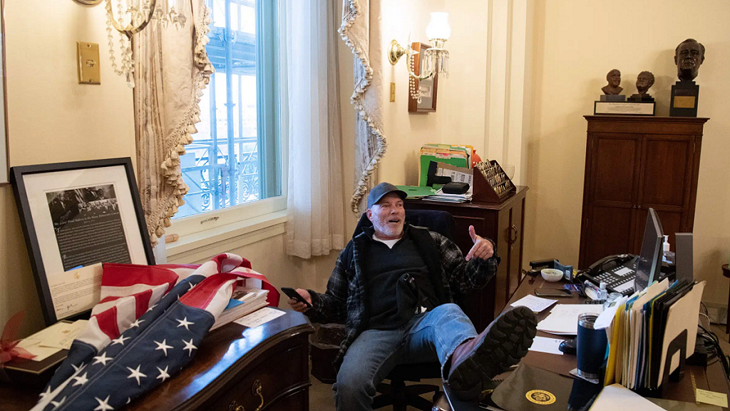 d.c. chaos anarchist storms capital feet up on Nasty Pelosi desk