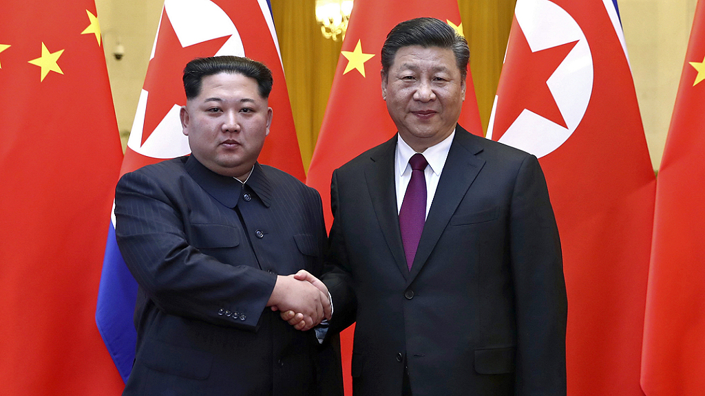Kim Jong-Un shakes hands with Xi Jinping the president of China
